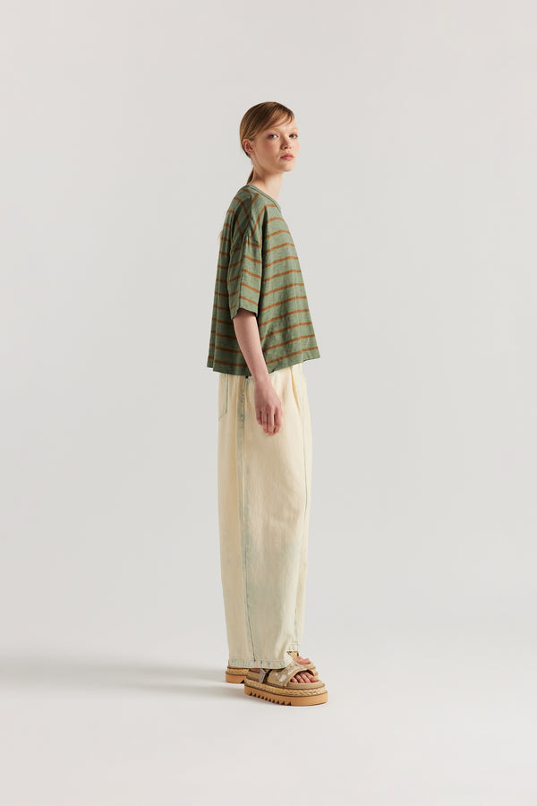 Side view of model in the Olive/Tan stripe, Obelisk Feeder Stripe Tee in yarn-dyed slub cotton with relaxed boxy fit