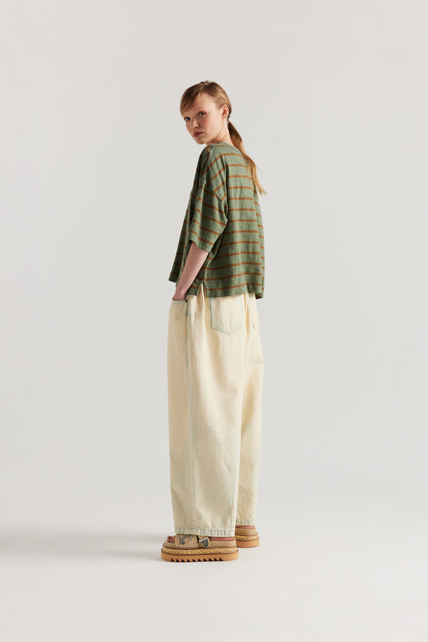 back view of model in the Olive/Tan stripe, Obelisk Feeder Stripe Tee in yarn-dyed slub cotton with relaxed boxy fit