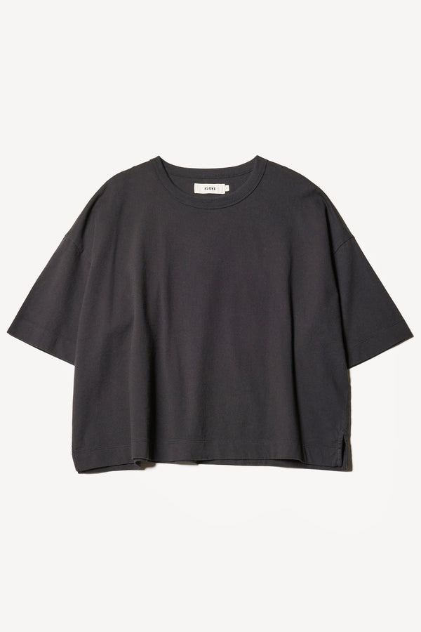 flat front of Obelisk Tee in Jet Black showing relaxed fit and straight hem with side split