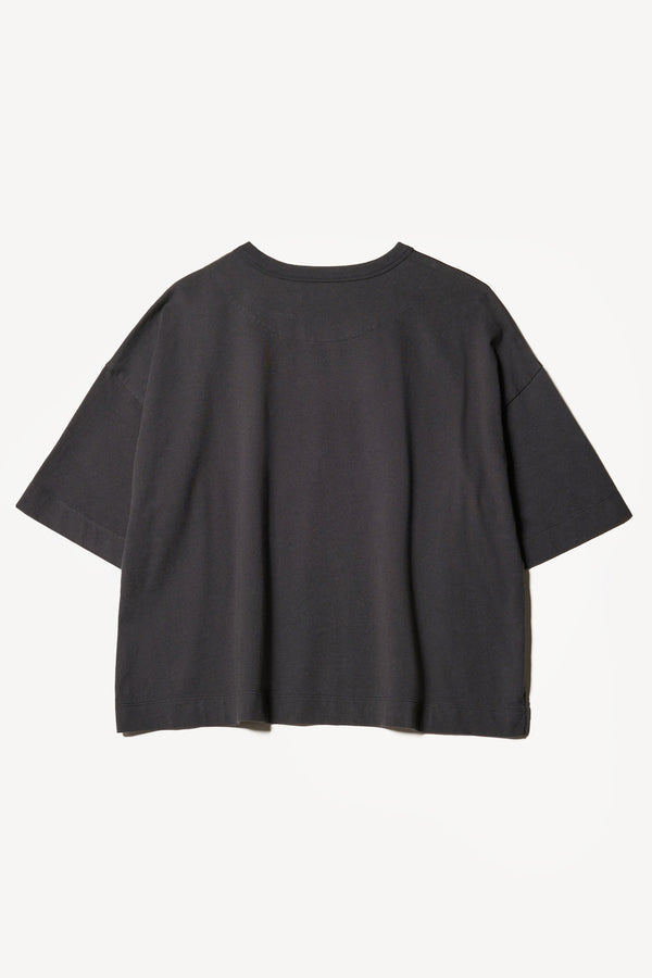 flat back of Obelisk Tee in Olive oil, showing relaxed fit and straight hem with side split