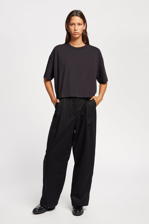 Front of Model wearing Obelisk Tee in Jet Black, showcasing oversized silhouette and dropped shoulders