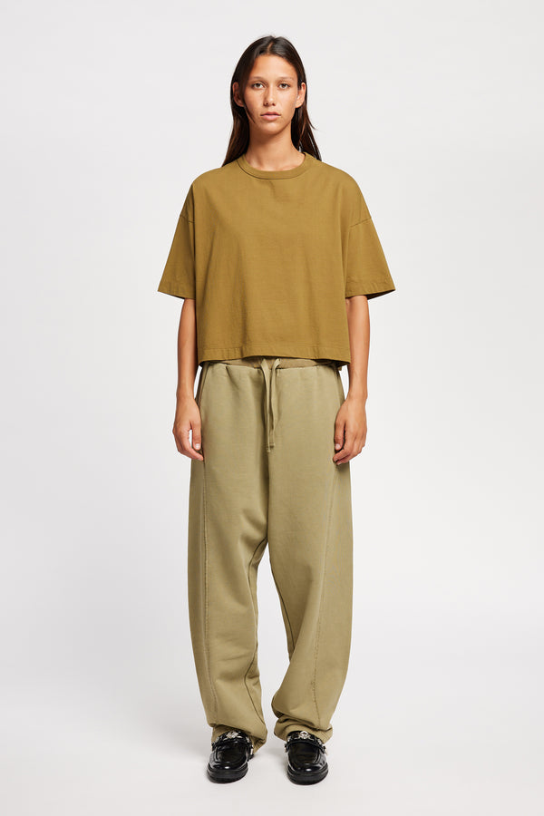 Model wearing Obelisk Tee in Olive Oil, showcasing oversized silhouette and dropped shoulders