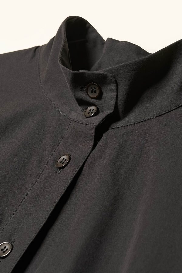 Close up detail shot of the Odeum Dress  mock neck round collar in black mid-weight cotton. 