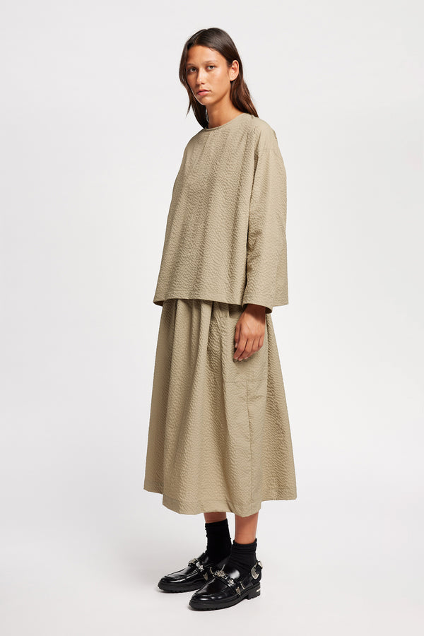 Front of the Model wearing the omit Top a relaxed-fit Japanese nylon seersucker top in Stone/ beige with dropped sleeves and a round neckline.