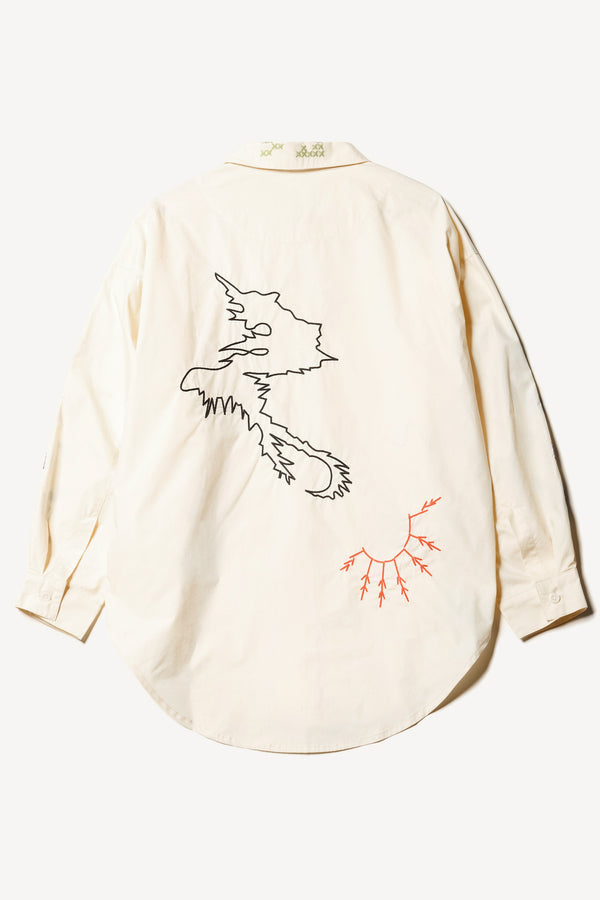 Flat back of Ecru One World Shirt with embroidered Arecibo motifs on collar, sleeves, and front. Classic collar and full placket.