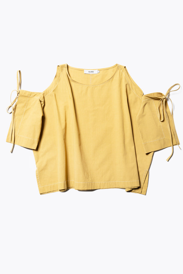 Flat Front view of the Open Shoulder Top in mustard. Featuring a relaxed fit and side-tie sleeve details.