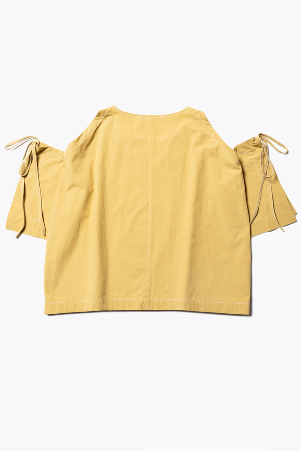 Flat Back view of the Open Shoulder Top in mustard. Featuring a relaxed fit and side-tie sleeve details.