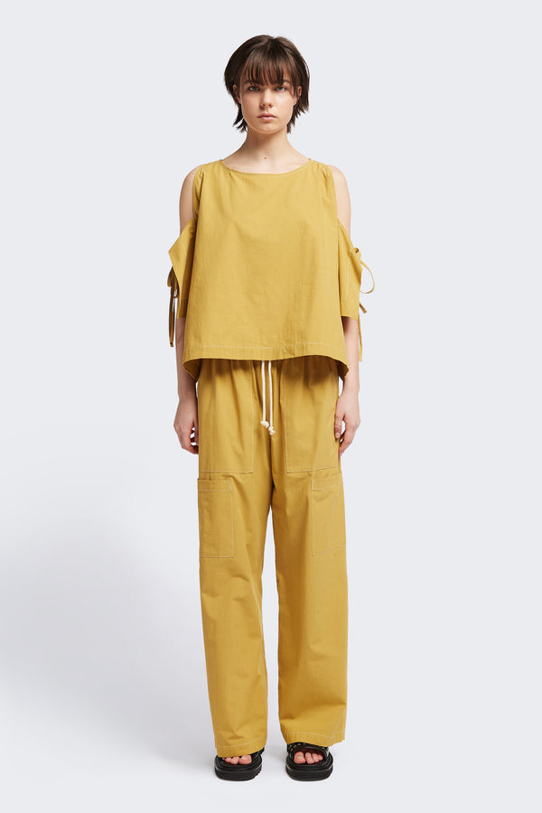 Front view of the Open Shoulder Top in mustard. Featuring a relaxed fit and side-tie sleeve details.