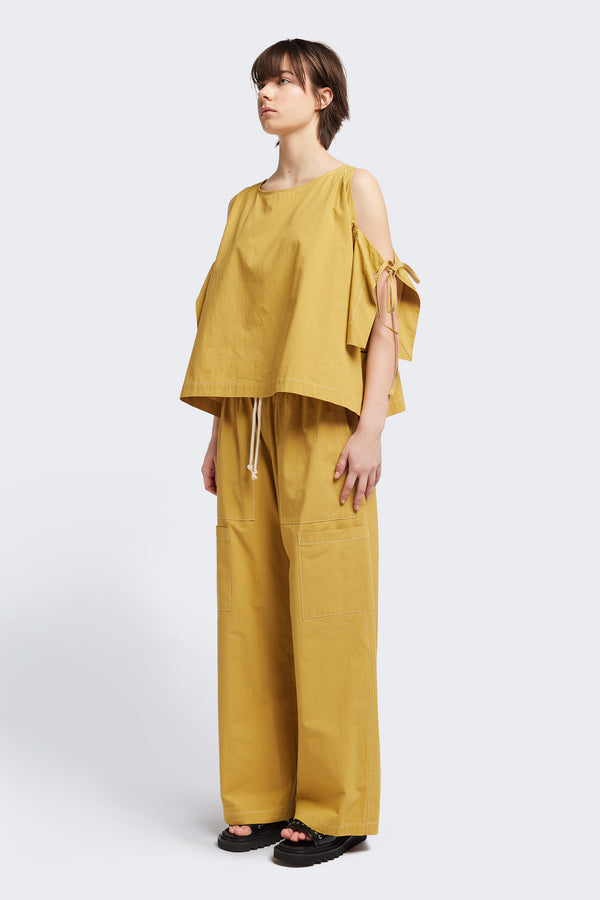 Front view of the Open Shoulder Top in mustard. Featuring a relaxed fit and side-tie sleeve details.
