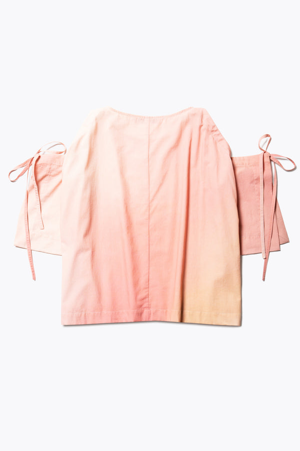 Flat back view of the Open Shoulder Top in pink/ orange cloud print. Featuring a relaxed fit and side-tie sleeve details.