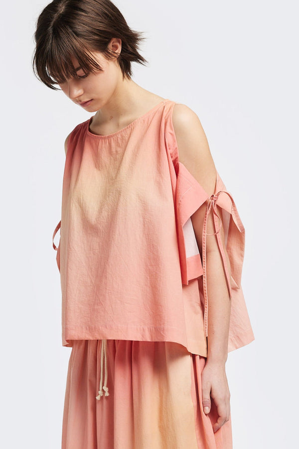 Front view of the Open Shoulder Top in pink/ orange cloud print. Featuring a relaxed fit and side-tie sleeve details.