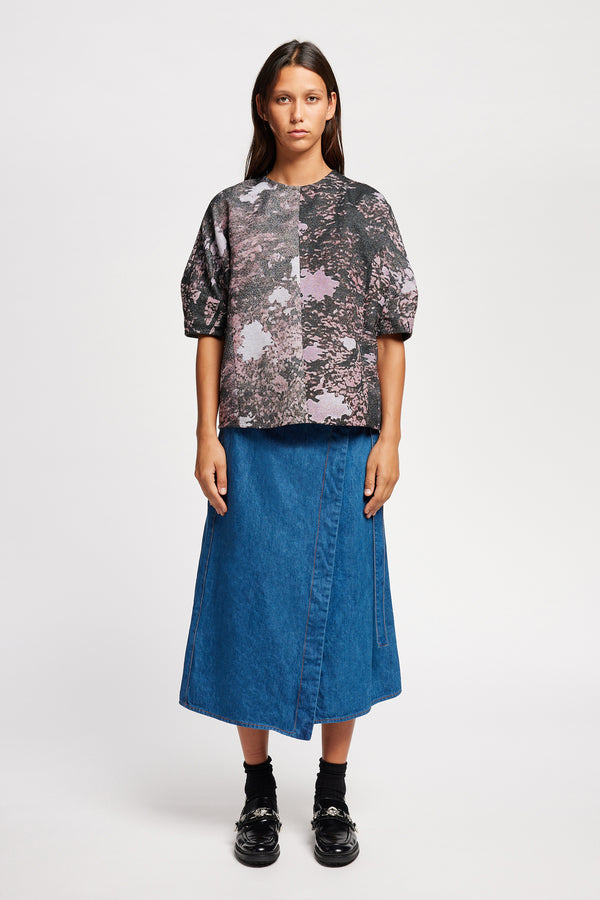 Front of the model in the forge top in purple print featuring a unique woven jacquard fabric with real tree camouflage pattern, sculptured panelled sleeves, and a contemporary fit
