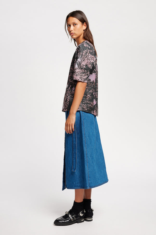 Side of the model in the forge top in purple print featuring a unique woven jacquard fabric with real tree camouflage pattern, sculptured panelled sleeves, and a contemporary fit