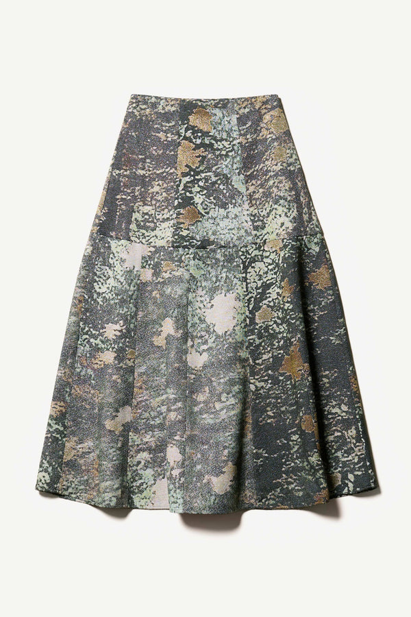 Flat Front of the Optic Skirt a midi-length A-line skirt in textured jacquard green print fabric with a forest-inspired pattern, designed by Kloke