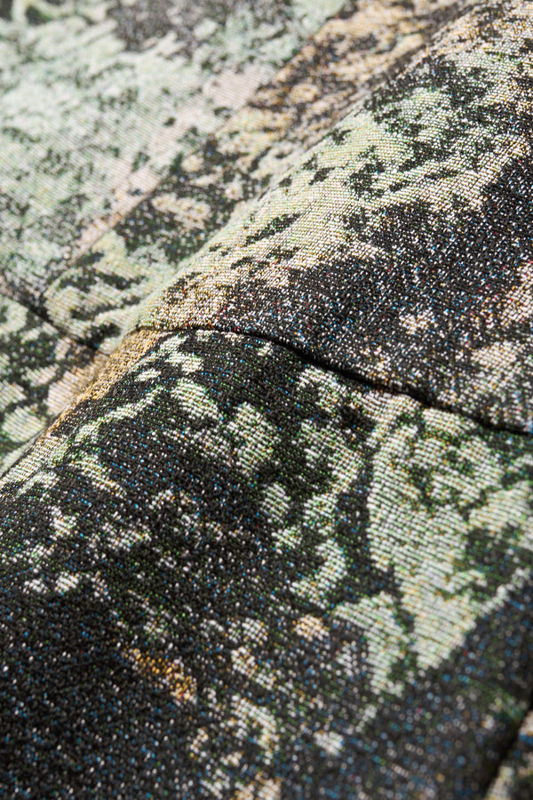 Close up fabric detail shot of the Optic Skirt in green print featuring a unique woven jacquard fabric with tree camouflage pattern