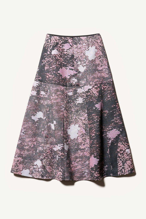 Flat Back the Optic Skirt a midi-length A-line skirt in textured jacquard purple print fabric with a forest-inspired pattern, designed by Kloke