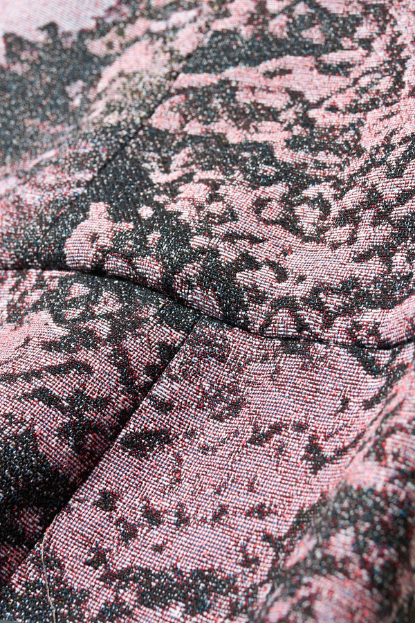 Close up fabric detail shot of the Optic Skirt in purple print featuring a unique woven jacquard fabric with tree camouflage pattern