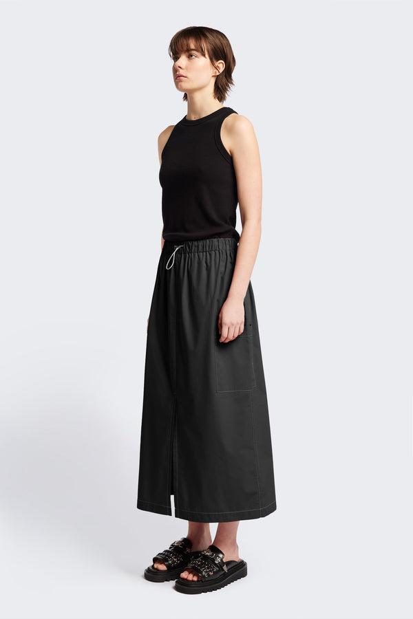 The Opus Skirt Black with white contrast topstitch is a straight, mid-length skirt with elasticated waist with toggle adjustment, side patch-pockets and centre-front split. 