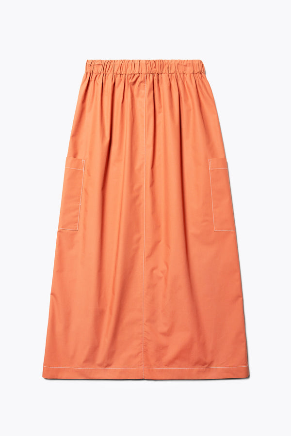 The back of the Opus Skirt Rust, a straight, mid-length skirt with an elasticated waist and side patch-pockets. Made from 100% cotton. 