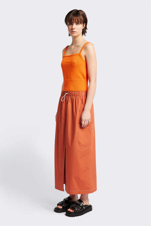 The Opus Skirt Rust with white contrast topstitch is a straight, mid-length skirt with elasticated waist with toggle adjustment, side patch-pockets and centre-front split. 