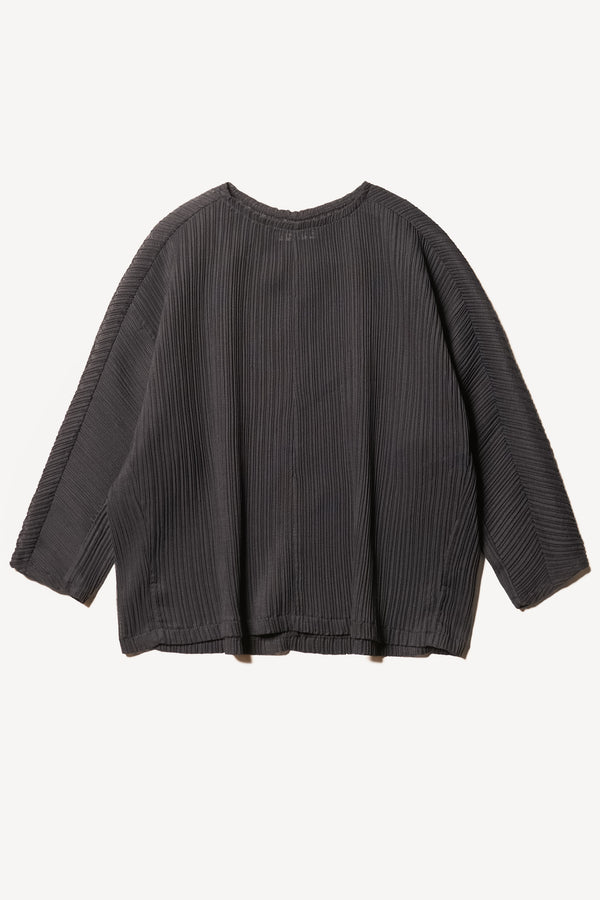 Flat front of the Loose-fit crinkle top in black made from Japanese recycled polyester, featuring panelled seams and a textured finish.