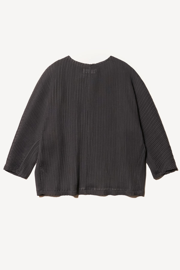 Flat back of the Loose-fit crinkle top in black made from Japanese recycled polyester, featuring panelled seams and a textured finish.