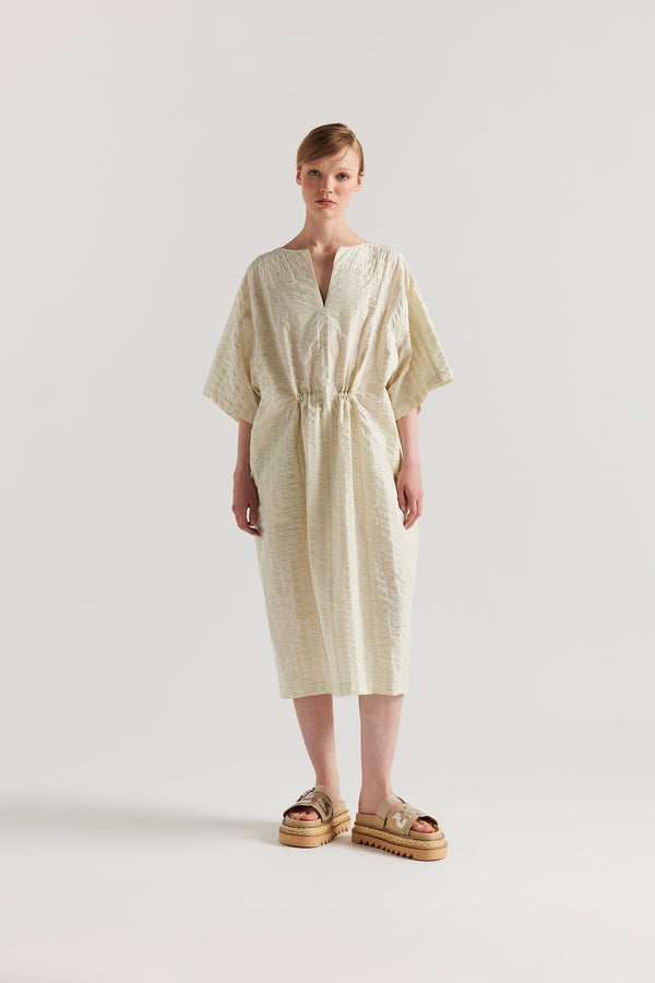 Front view of Woman wearing the Origin Dress in gingham seersucker butter check. A relaxed silhouette with internal tie, clean neckline, and subtle underarm split detail.