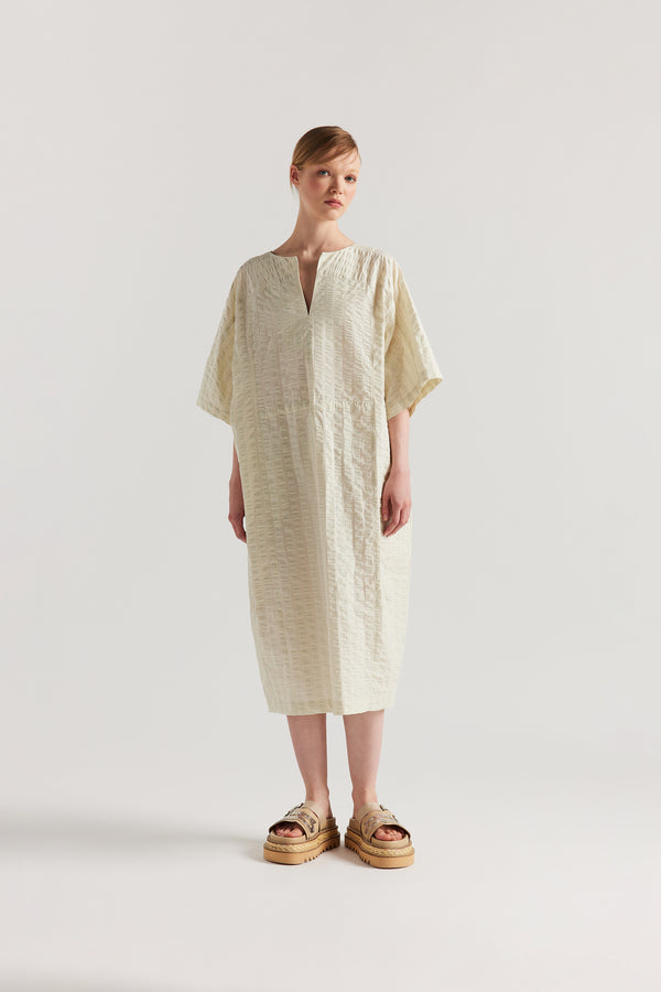 Front view of Woman wearing the Origin Dress in gingham seersucker butter check. A relaxed silhouette with internal tie, clean neckline, and subtle underarm split detail.