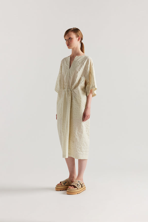 Front Angle view of Woman wearing the Origin Dress in gingham seersucker butter check. A relaxed silhouette with internal tie, clean neckline, and subtle underarm split detail.