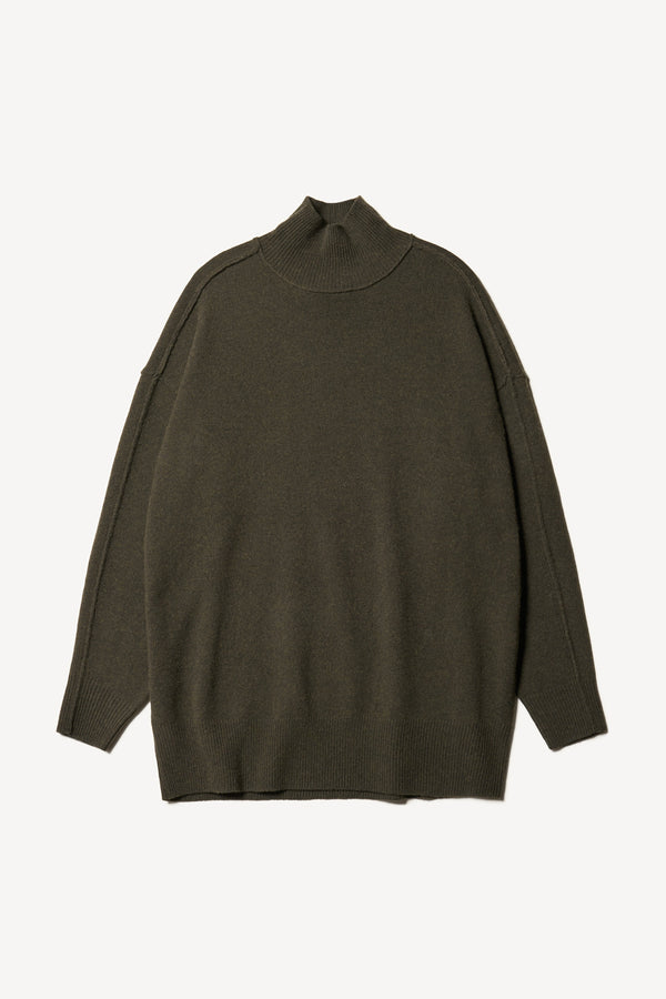 Flat front of Overflow long knit, high neck wool blend sweater with exposed seams in darkest green