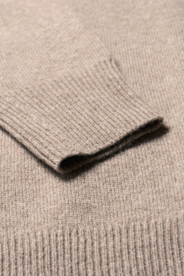Close up fabric shot of the Overflow long knit, high neck wool blend sweater with exposed seams in taupe