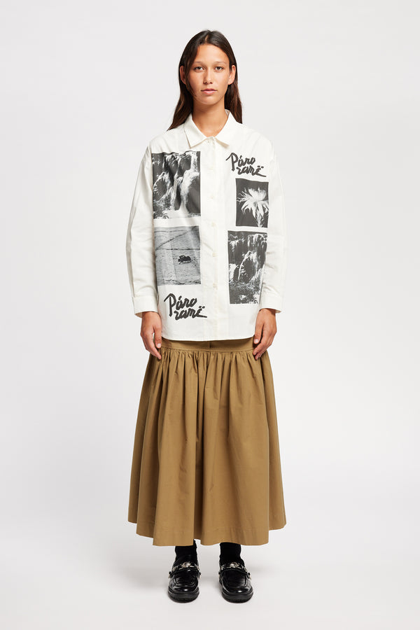 Front of Model wearing the Pano shirt, an off-white printed shirt with relaxed fit, structured collar, and vintage-photo placement print.