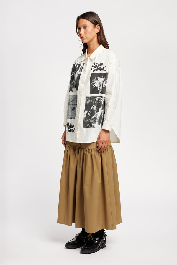 Front of Model wearing the Pano shirt, an off-white printed shirt with relaxed fit, structured collar, and vintage-photo placement print.