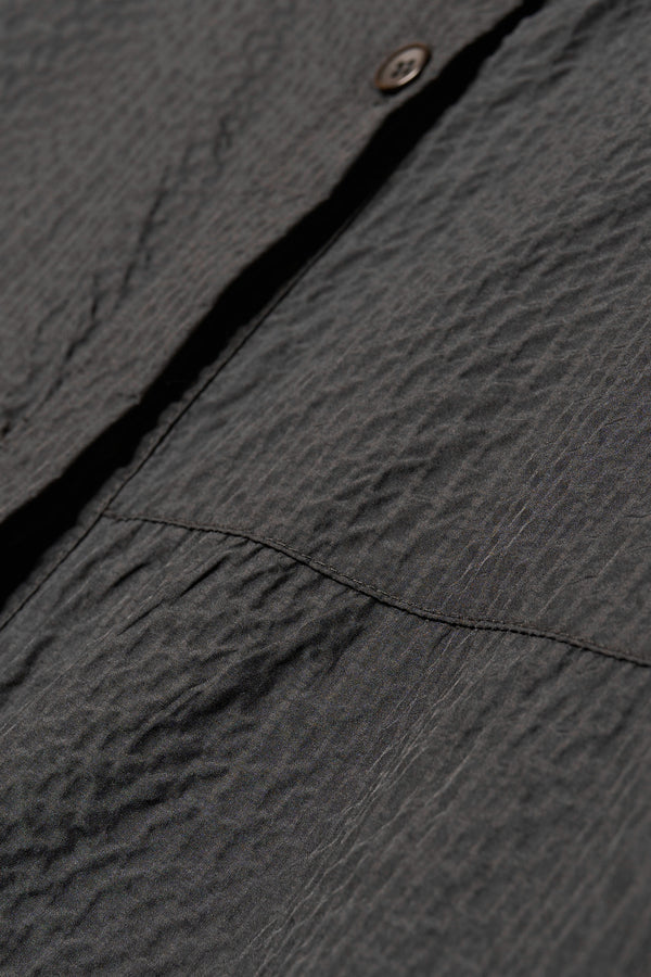 Close up fabric detail shot of the Parapet Dress in Jet Black lightweight seersucker nylon.