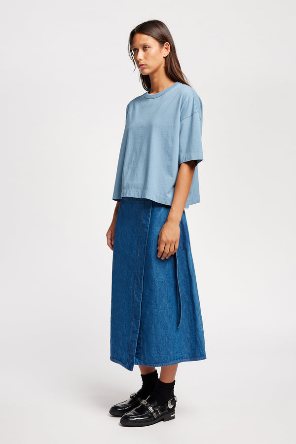 Front of Model wearing Obelisk Tee in blue, showcasing oversized silhouette and dropped shoulders