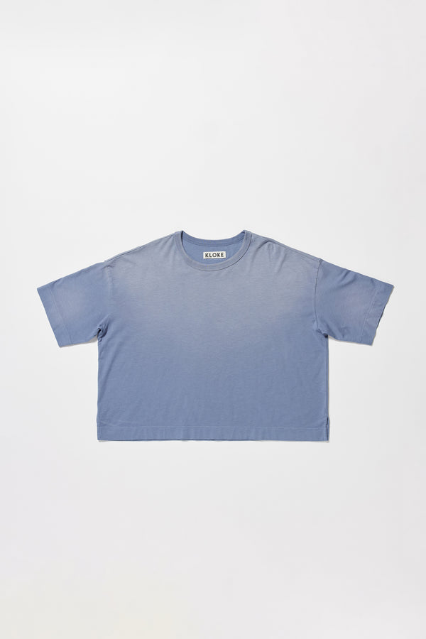flat front of Passage Tee in blue fade, showing relaxed fit and straight hem with side split