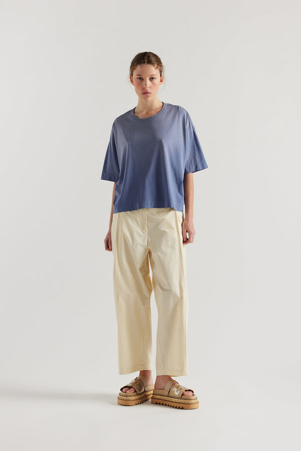Front of Model wearing Passage Tee in blue, showcasing oversized silhouette and dropped shoulders
