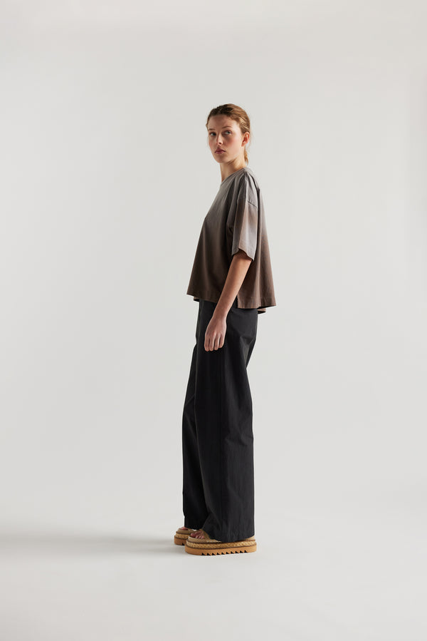 Side of Model wearing Passage Tee in brown, showcasing oversized silhouette and dropped shoulders