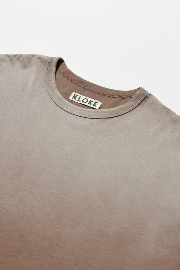 detail of Passage Tee in brown, showcasing oversized silhouette and dropped shoulders