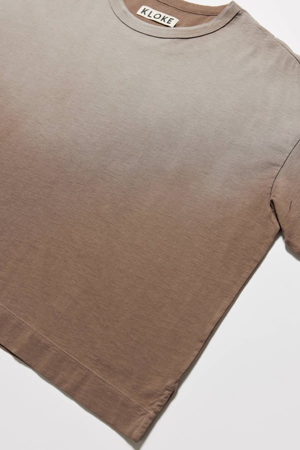 detail of Passage Tee in brown, showcasing oversized silhouette and dropped shoulders