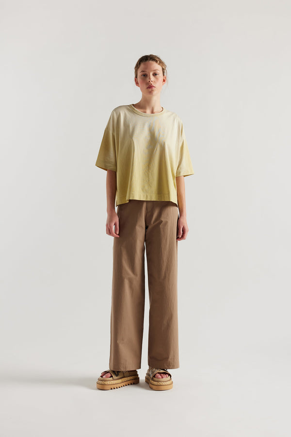 Front of Model wearing Passage Tee in chartreuse, showcasing oversized silhouette and dropped shoulders