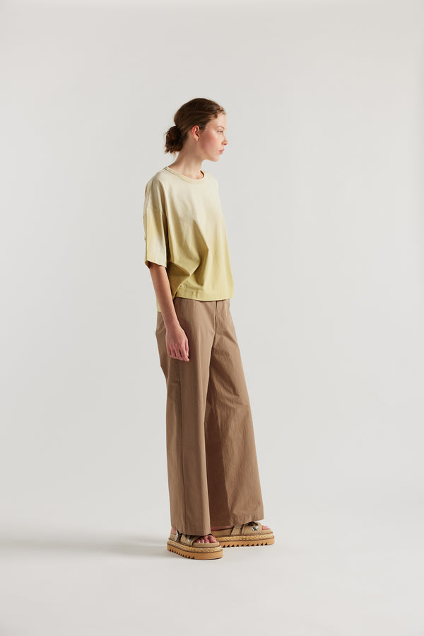 Front of Model wearing Passage Tee in chartreuse, showcasing oversized silhouette and dropped shoulders