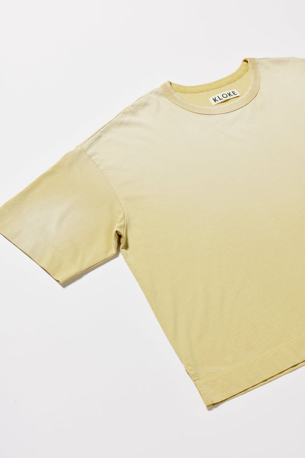 Detail shot of the Passage Tee in chartreuse, showcasing oversized silhouette and dropped shoulders