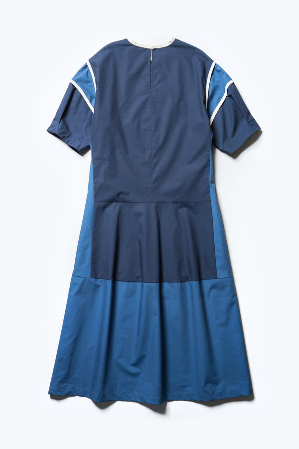 Flat back of The Patch dress in Blue, a colour-block dress with tonal hues, contrast-bound seams, round neckline with keyhole back, dropped sleeves with tucks, and a slightly flared skirt, perfect for a summer vibe.