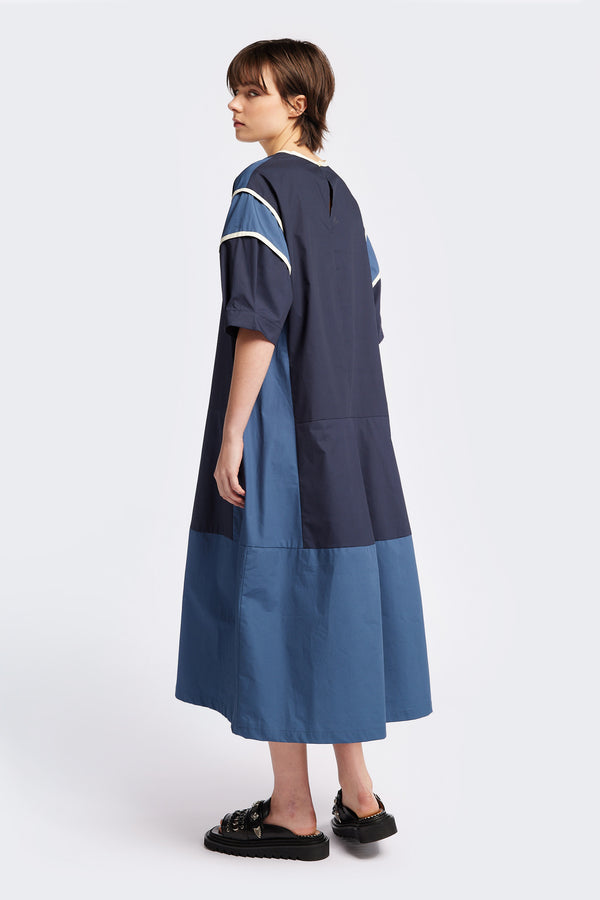 Back of The Patch dress in Blue, a colour-block dress with tonal hues, contrast-bound seams, round neckline with keyhole back, dropped sleeves with tucks, and a slightly flared skirt, perfect for a summer vibe.