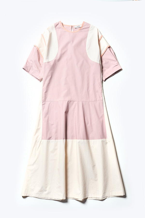 Flat Front of The Patch dress in Peach, a colour-block dress with tonal hues, contrast-bound seams, round neckline with keyhole back, dropped sleeves with tucks, and a slightly flared skirt, perfect for a summer vibe.