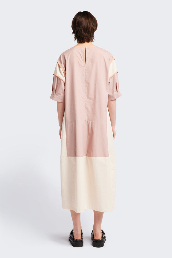 Back of The Patch dress in Peach, a colour-block dress with tonal hues, contrast-bound seams, round neckline with keyhole back, dropped sleeves with tucks, and a slightly flared skirt, perfect for a summer vibe.