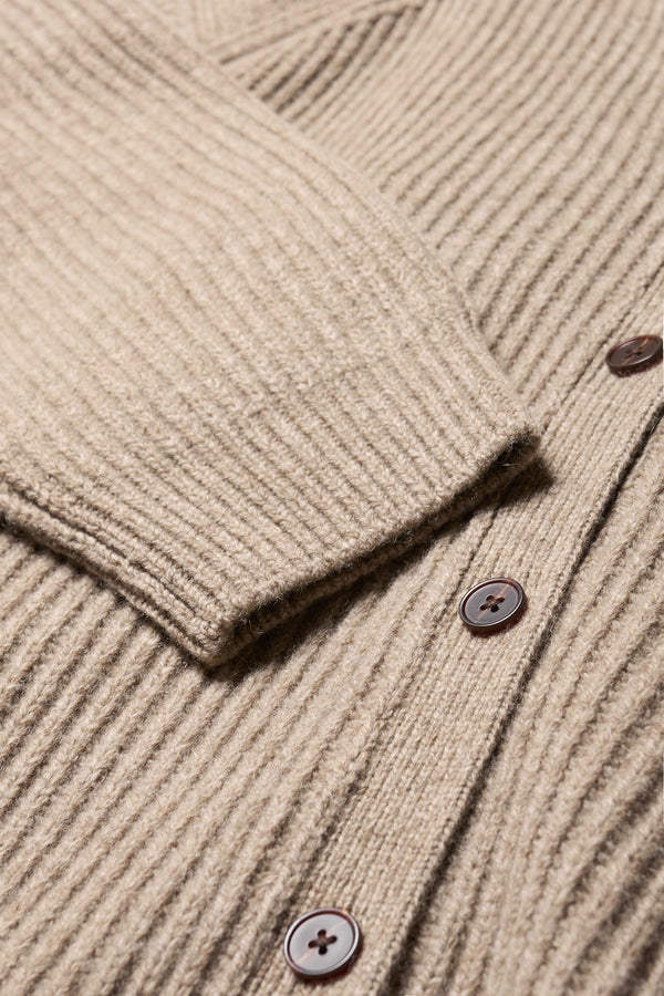 Close up fabric detail of the Pause oversized ribbed wool cardigan with button closure in light taupe