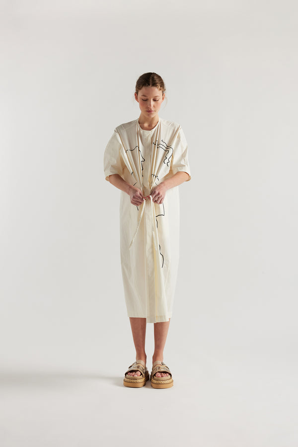 front view of female model in the ecru Pensive Dress with black embroidered motifs and round neckline