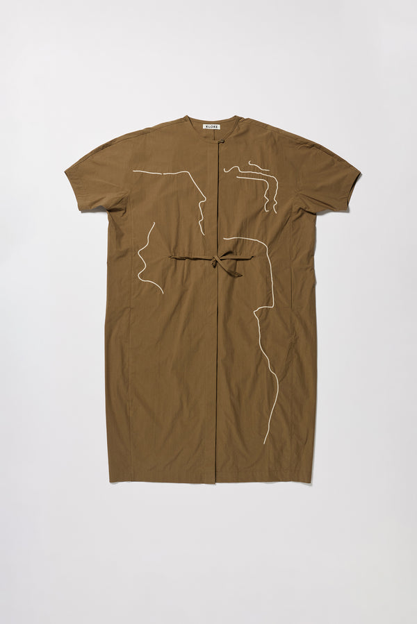 Flat front of the Olive Pensive Dress with black embroidered motifs and highlighting the encased self tie waist relaxed